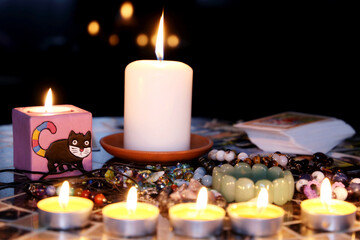 Fortune telling, seeing the destiny and astrology. Candles, tarot cards and crystals on the round table