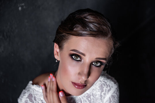Close-up beauty portrait of young woman. Bright girl, bride with professional evening make-up.