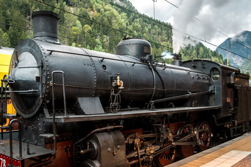 Fototapeta na wymiar Old fashioned train vagon and Steam locomotive in the station of Brunico Bruneck in Val Pusteria - Pustertal, Trentino Alto Adige, Südtirol - South Tyrol, Italy