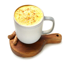 Cup of delicious turmeric latte on white background