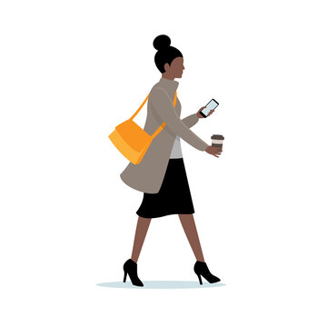 Business woman walking in hurry, holding cell phone and coffee cup.