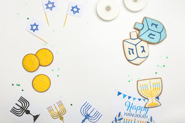 Frame made of different symbols of Hanukkah on white background