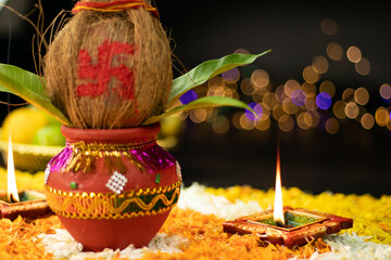 Sharp Straight Flames Illuminating From Clay Diya Deep Dia Placed On Marigold Flower Rangoli With Kalash On The Side. Navratri Pooja, Dussehra Puja, New Home Inauguration And Shubh Deepavali Theme