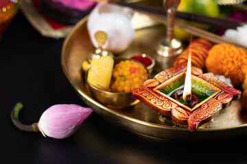 Clay Diya Deep Dia Illuminated in Pooja Thali With Genda Flower, Ghanti And Sankh. Diwali, New Year, Navratri, Dussehra Puja, Deepawali, Karva Chauth, Teej, Ganesh Chaturthi Or Shubh Deepavali Theme