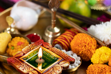 Clay Diya Deep Dia Illuminated in Pooja Thali With Genda Flower, Ghanti And Sankh. Diwali, New Year, Navratri, Dussehra Puja, Deepawali, Karva Chauth, Teej, Ganesh Chaturthi Or Shubh Deepavali Theme