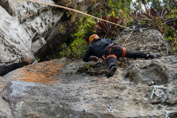 Old man climber on the mountain