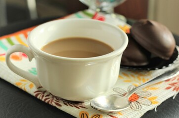 closeup cup of coffee with chocolate cookies spoon table eat dessert sweet tasty food nobody towel milk hot drinks cappuccino latte americano