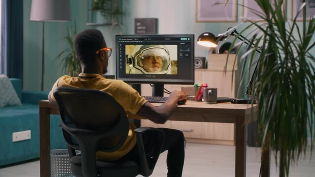 Black guy using photo editor on computer