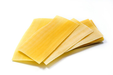 Uncooked raw lasagna pasta isolated on white background. Stack of dried uncooked lasagna pasta sheets