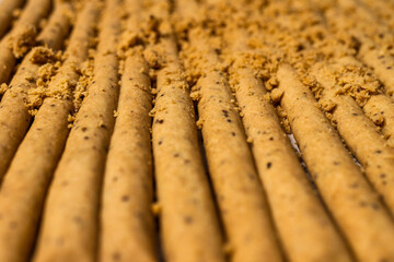 Close up view on a set of raw sticks of artisan bread with seeds on top