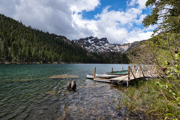 Photo of a dock with row boats and the Sierra Nevada mountains in the background at Lower Sardine...