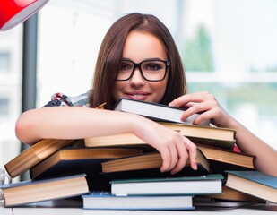 Young woman student with many books