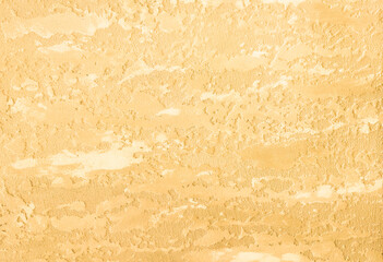 Yellow, abstract background with scuffs and roughness. An old wall with a warm, yellow texture.