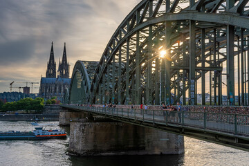 COLOGNE, GERMANY, 23 JULY 2020 Sunburst sunset right on the Hohenzollern Bridge, Cologne Cathedral on the background