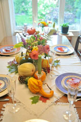 Fall harvest pumpkin and gourds arranged for beautiful seasonal table decor for family Thanksgiving dinner or autumn wedding.