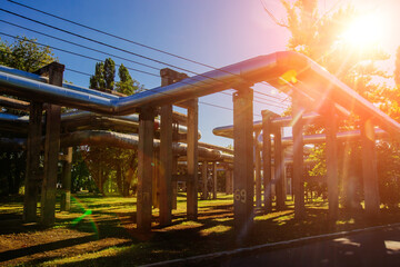 Steel pipelines outgoing from the plant at sunny day