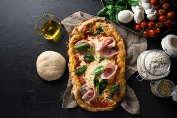 top view Pizza Romana alla pala with ingredients on dark background