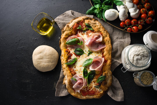 top view Pizza Romana alla pala with ingredients on dark background Stock  Photo | Adobe Stock