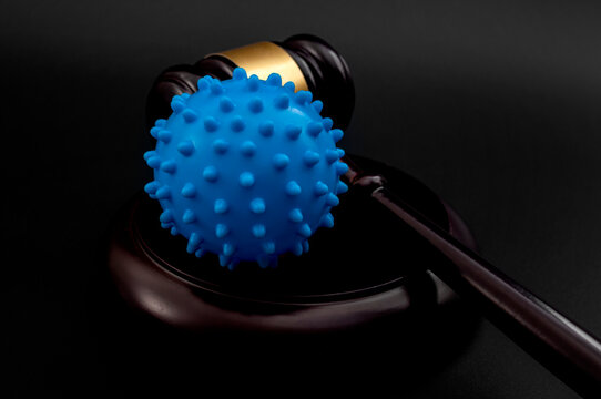 Legality Of Federal Vaccine Mandates, Covid19 Public Health Crisis And Impact Of Mandatory Covid Vaccines Concept With Coronavirus Model And Judge Gavel Isolated On Black Background