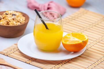 fresh orange juice with whole orange cereals for breakfast or a snack on marble bottom
