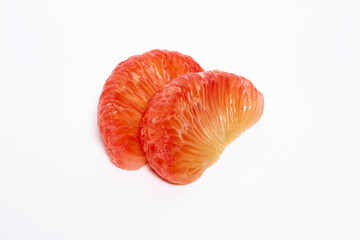 2 grapefruit peeled, orange-red flesh stacked on a white background