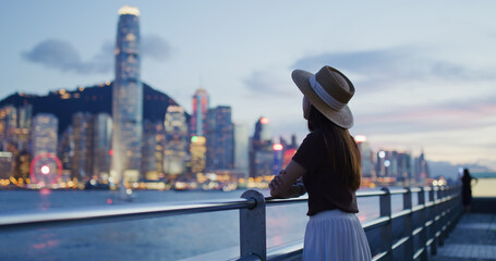 Woman traveler visit beautiful Hong Kong night view
