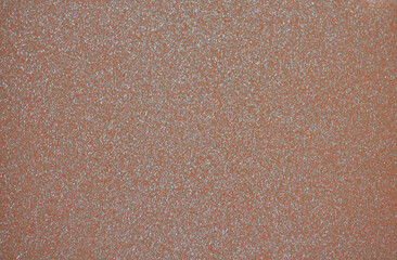 Fototapeta premium Dark brown monochrome background with a scattering of small silvery sparkles.