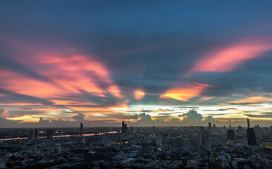 Bangkok, thailand -Sep 17, 2021 : Fantastic colorful sunset sky over the bangkok city skyscrapers with bright glowing lights at dusk give the city a modern style. Copy space, Selective focus.