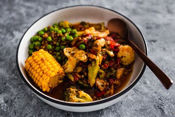 vegan mixed vegetable roast with spicy broth, healthy plant-based food
