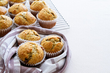 Freshly baked homemade banana chocolate chip muffins; Out of the oven muffins in muffin cups