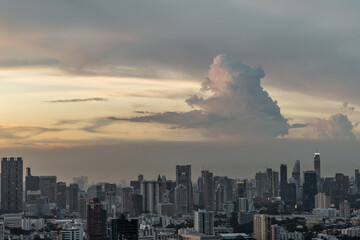 Fototapeta premium Bangkok, Thailand - Aug 23, 2021 : Aerial view of Beautiful sunset over large metropol city in Asia. With tall building and skyscraper in background. Monotone, No focus, specifically.