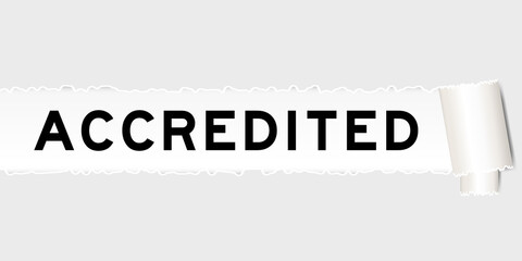 Ripped gray paper background that have word accredited under torn part