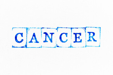 Blue color ink rubber stamp in word cancer on white paper background