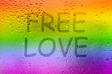 The inscription on the sweaty glass. The word FREE LOVE written on glass with rainbow
