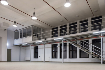 Interior of a large industrial space with mezzanine at night