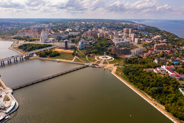 Scenic general aerial view of Cheboksary cityscape on banks of Volga River on sunny summer day, Chuvashia, Russia