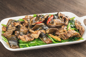 Chinese Cuisine: fried eel with a plate of cabbage