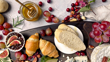 Assorted cheeses on wooden board.