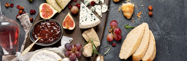 Cheese assortment on dark background.