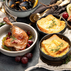 French food assortment on dark background.