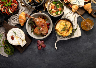 French food assortment on dark background.