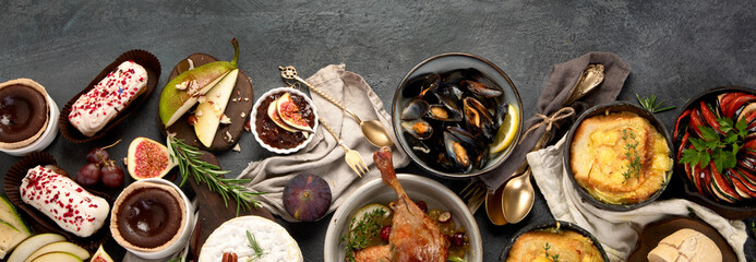 French food assortment on dark background.