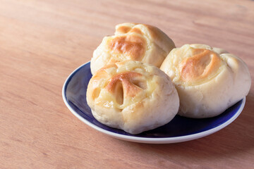 cream bread in blue plate on wooden background