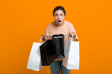 Indian woman holds shopping bags in hands. Sale and Black Friday concept