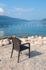 Fototapeta na wymiar An empty beach chair by the Adriatic seaside in Montenegro. 