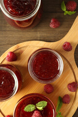 Concept of tasty food with raspberry jam on wooden background