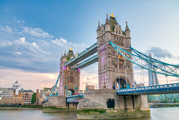 LONDON, UK - JUNE 30TH, 2015: Tower Bridge and modern city buildings exterior at sunset with river...
