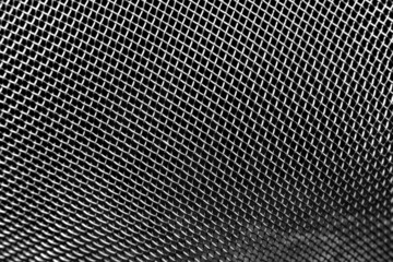 The texture of a metal lattice on a dark background