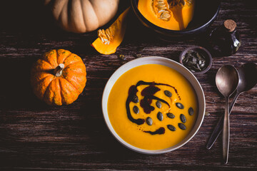 Homemade pumpkin soup with pumpkin oil and seeds