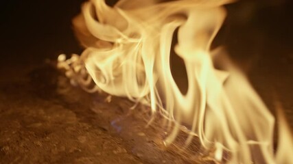 Slow motion video of a line of fire. The fire begins to burn the flame goes in front of the gasoline.